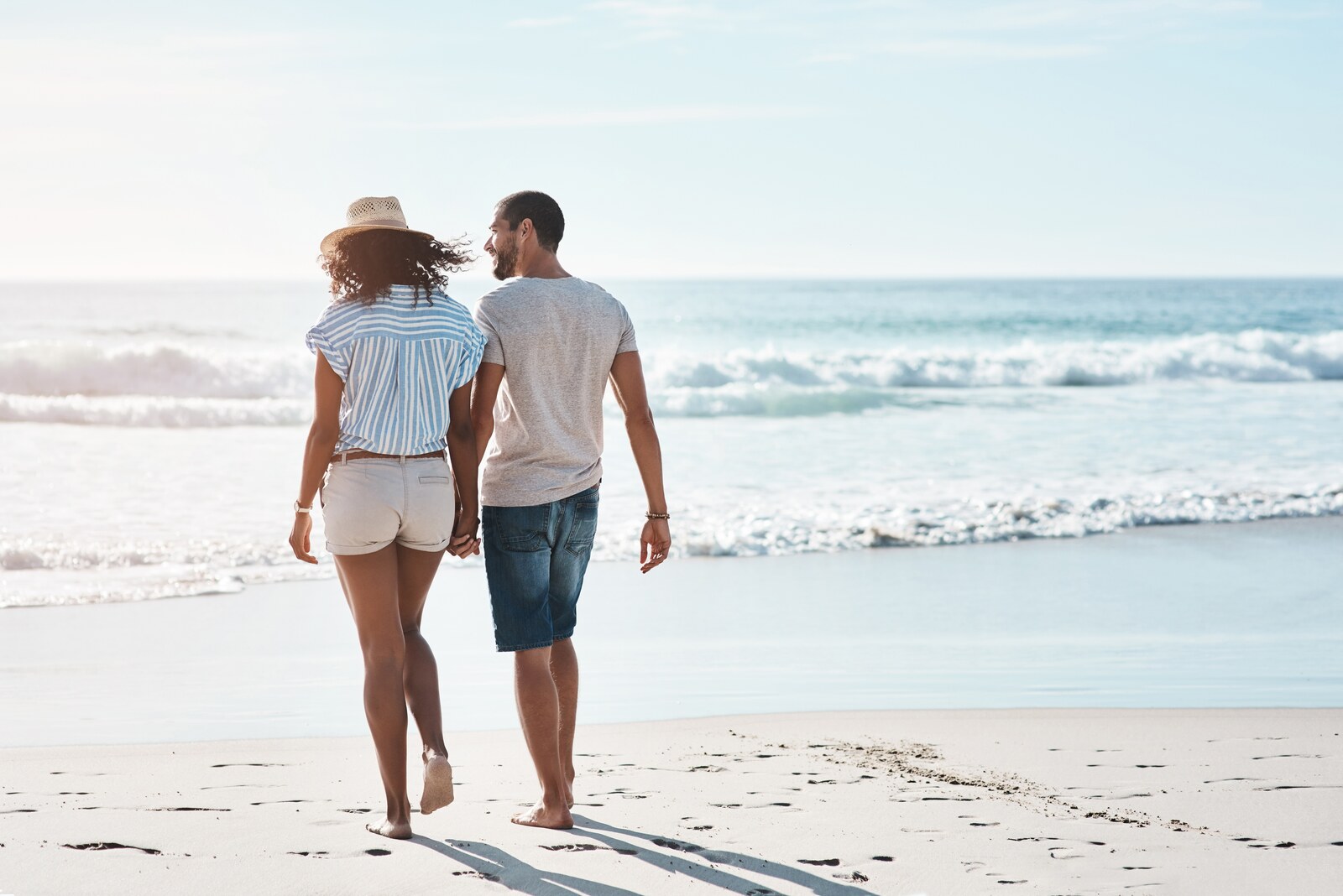A couple enjoying a romantic walk on Hua Hin Beach 