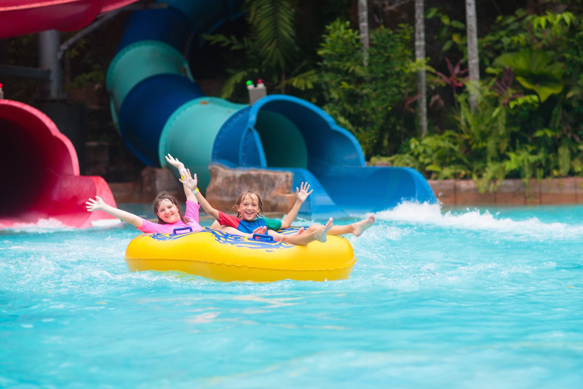 Kids enjoy a waterpark tourist attraction in Thailand.