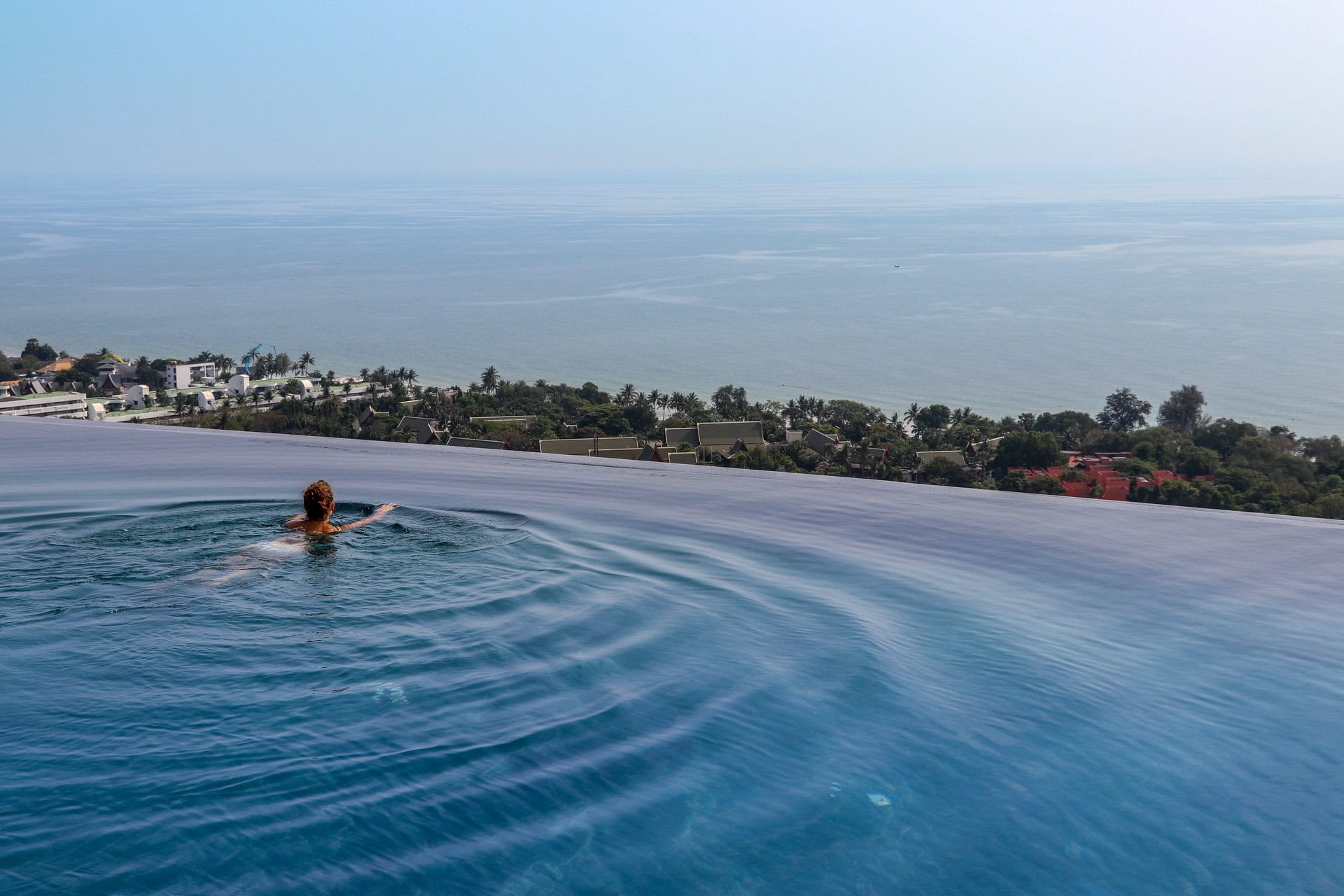 A guest swims in the infinity pool in Hua Hin